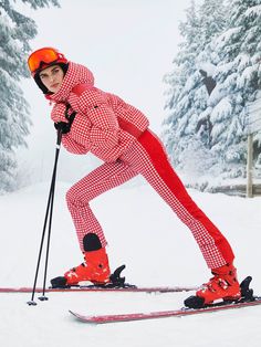 a woman riding skis down a snow covered slope