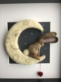 a stuffed rabbit is sitting on the moon