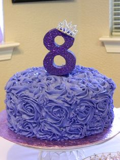 a purple cake with the number eight on top