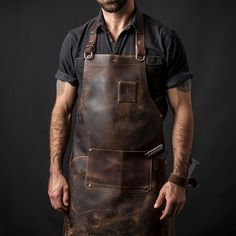 The Leather Apron for Blacksmithing: a symbol of tradition, craftsmanship, and resilience in the forge! Crafted with precision and passion, our apron is designed to meet the rigorous demands of blacksmithing while exuding timeless style. Blacksmith Clothes, Blacksmith Costume, Blacksmith Apron, Medieval Blacksmith, Welding Apron, Big Muscle, Welding Gear, Art Apron, The Forge