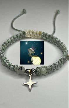 a bracelet with a star charm and two charms attached to the clasp, on a white background