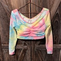 Long Sleeve Rainbow Crop Top. Has A Stretchy Textured Spandex Material That Is Double Lined. Super Cute Cross Cross Back, With A Cut Out. Moisture Wicking Material, And Also Has Removable Cups On The Inside. Long Sleeves Have A Hole Detail For Your Thumb To Peek Through. Top Could Easily Be Worn To Work Out, Or Just Worn Casually. Brand New Tag Attached. Size Extra Large, But Runs A Little On The Smaller Side. Multicolor Yoga Tops, Stretch Multicolor Top For Yoga, Multicolor Stretch Top For Yoga, Stretch Multicolor Yoga Top, Multicolor Stretch Long Sleeve Crop Top, Multicolor Long Sleeve Stretch Crop Top, Multicolor Workout Tops For Spring, Rainbow Crop Top, Cutout Crop Top