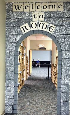 an entrance to a room with a sign on the wall that says welcome to ronoe