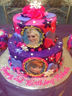 there is a cake decorated with princesses faces on it