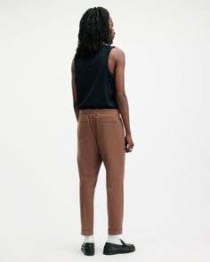 Traditional tailoring, modernized. The Tallis Pants are crafted from a conscious cotton-wool blend fabric with a slim, tapered leg – finished with a cropped ankle, multiple pockets and front pleats. They've got an ease to them that gives you endless styling options.  These pants are designed to a slim fit Tapered leg Mid-rise Cropped tapered fit Subtle pleat detailing from the waistband Tapered Chinos For Workwear, Allsaints Relaxed Fit Cotton Bottoms, Brown Tapered Leg Chinos For Work, Fitted Allsaints Bottoms For Spring, Allsaints Straight Leg Work Bottoms, Allsaints Relaxed Fit Bottoms For Spring, Allsaints Casual Bottoms For Fall, Allsaints Casual Fall Bottoms, Workwear Chinos With Hip Pockets And Tapered Leg