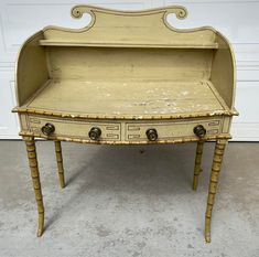 an old desk with two drawers on it