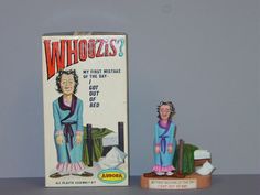 a toy doll next to a box with an image of a man in pajamas on it