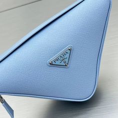 SHOP MORE LUXURY PRODUCTS HERE Description Prada Triangle Mini Bag Blue For Women, Women’s Bags 9.8in/25cm Introduced for the first time on trunks designed by Mario Prada, the Prada triangle expresses uniqueness and modernity through its minimalist and universal silhouette, reinvented in a different way every season. Its geometric shape inspires this mini bag with a modernist and modular design that lets it be worn in a variety of ways: the two triangles that compose it can be separated an Classic Blue Pouch Bag, Blue Pouch Bag For Business, Blue Business Pouch Bag, Business Blue Pouch Bag, Luxury Blue Bag With Zipper Pocket, Prada Triangle, Louis Vuitton Shirt, Triangle Bag, Fabric Handbags