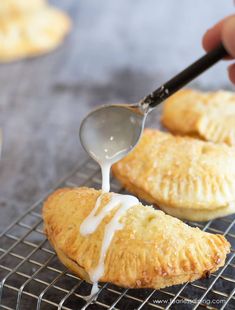 gluten free air fryer hand pies on a cooling rack with a spoon