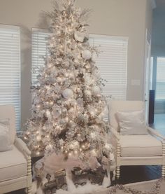 a white christmas tree in a living room