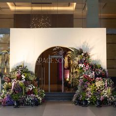 an entrance to a building decorated with flowers