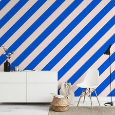 a room with blue and pink stripes on the wall