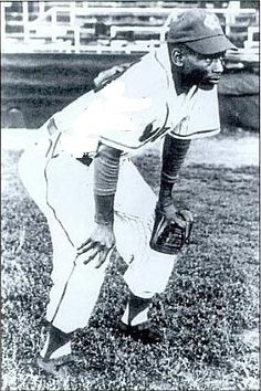 an old black and white photo of a baseball player