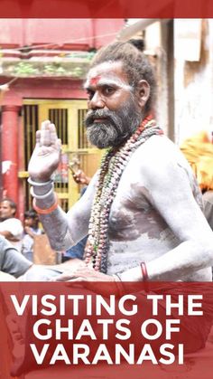 a man with white paint on his face and beard is standing in front of a crowd