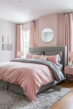 a bedroom with pink walls and grey bedding