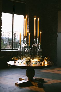 a table with candles on it in front of a window