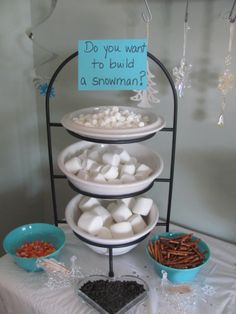 three tiered trays filled with marshmallows and pretzels