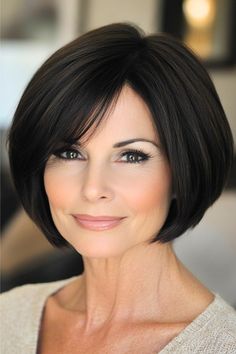 Jaw-Length Bob Hairstyle on a softly smiling woman in her 50s with short dark brown hair.