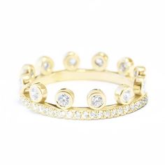 a yellow gold ring with diamonds on it