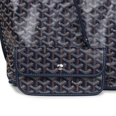 This Goyard Anjou PM bag is in navy Goyardine canvas with palladium hardware, contrast stitching, navy chevroches calfskin lining, and a detachable pouch.This bag is reversible.Origin: FranceCondition: New and never wornAccompanied by: Goyard dustbag, retail UPC, removable pouchMeasurements: 18.5" x 11" x 5.9" ; 7.5" shoulder strap Everyday Monogram Canvas Bag With Silver-tone Hardware, Navy Shoulder Bag With Dust Bag For Travel, Travel Bag With Monogram Canvas And Silver-tone Hardware, Luxury Navy Tote Shoulder Bag, Luxury Navy Shoulder Bag For Everyday Use, Goyard Anjou, Madison Avenue, Calf Skin, Dust Bag