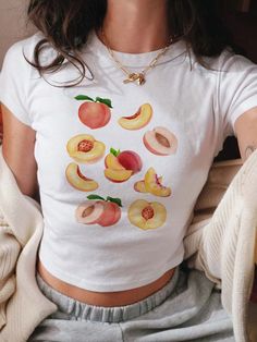 Peaches Baby Tee, Fruit Shirt, Peach Shirt, Vintage Fruit Tee, Peach Graphic T-Shirt, Aesthetic Fruit Shirt, Gift For Women *IMPORTANT PLEASE READ BEFORE PURCHASING* My store uses DTG (Direct to Garment) printing. This means the design is printed into the garment. This means it is designed to last longer than other printing processes. Due to this printing process the design colors may not be as vibrant as shown in the photos. There may at times be a slight difference between real and perceived c Fruit Print Fashion, Fruit Outfit, Fruit T Shirt, Fruitful Fashion, Coquette Shirts, Fruit Clothes, June Fashion, Peach Outfit, Fruit Clothing