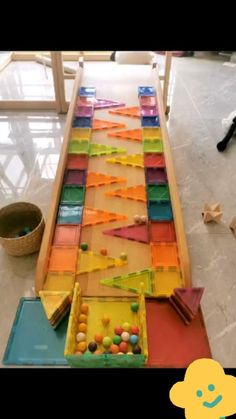 a child's play table made out of colored plastic beads and wooden pegs