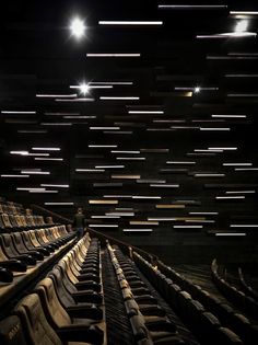 an empty theater with rows of seats and lights