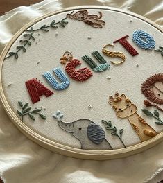 an embroidery project with animals and letters on it