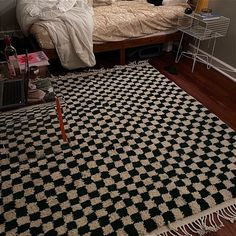 a bedroom with a bed, rug and other items on the floor in front of it