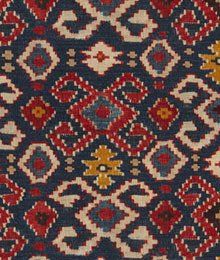 an old rug with many different colors and patterns