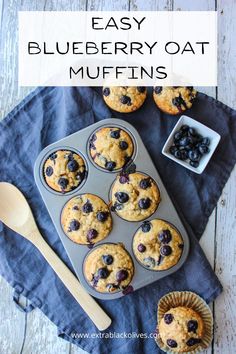 blueberry oat muffins in a muffin tin with fresh blueberries