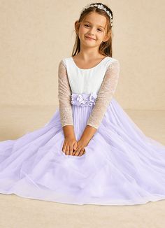 The Mae flower girl dress is a stunning A-line design that combines matte satin and delicate tulle with lace accents. Featuring an elegant illusion scoop neckline, long sleeves, and a stylish V-back with a zipper, it’s beautifully finished with charming bows, making it perfect for a fairytale wedding. Mauve Flower Girl Dress, Flower Girl Dress Long Sleeve, Lilac Flower Girl Dresses, Military Ball Dresses, Sage Dress, Special Event Dresses, Ivory Flower Girl Dresses, Lace Bride, Tulle Flower Girl