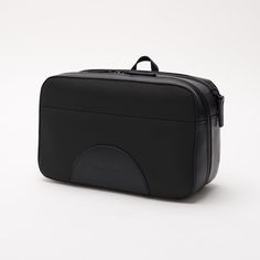 a black toilet bag sitting on top of a white table