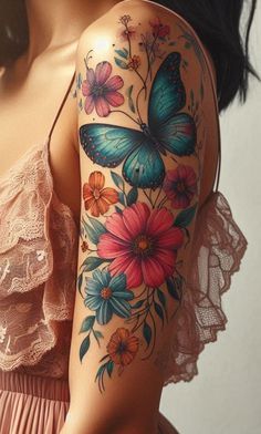 a woman's arm with flowers and butterflies painted on the upper half of her arm