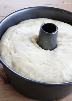 dough in a pan with a black ring on top