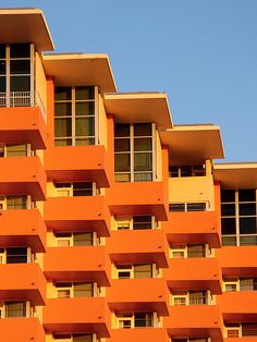 an orange building with balconies and windows