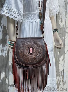 Show your personality with the Pink Stone Mandala shoulder/crossbody boho bag. The Pink Stone Mandala hand carved leather fringed boho bag is a stunning piece. Hand tooled with a pink feature stone in centre, a must for any bohemian Goddess. Handmade Genuine soft lush Leather Magnetic Close on front flap, zipper close inside under flap. Inside bag- Zip pocket and 2 open pockets Lined Measurements - Approx W26cm x H26cm Strap length Approx - 124cm 2 Colours available - Antique Brown & Black Featu Bohemian Pink Crossbody Shoulder Bag, Pink Bohemian Crossbody Shoulder Bag, Bohemian Hand Tooled Crossbody Bags, Stone Mandala, Inside Bag, Mandala Stones, Black Features, Pink Colour, Boho Bag