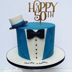 a blue and white cake with a top hat, bow tie and name on it