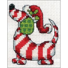 a red and white cross stitched dog with a green tag on it's collar