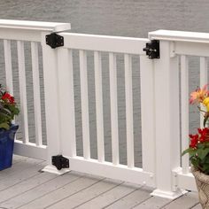 two pots with flowers are on the deck