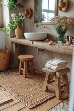 a bathroom with wooden stools, sink and mirror