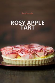 a close up of a pie on a plate with the words rosy apple tart