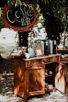 an old fashioned coffee bar is set up under a tree for guests to enjoy the day