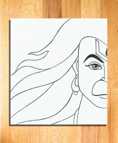 a drawing of a woman's face with long hair and earrings on a wooden floor