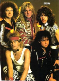 the band saxon are posing for a photo in their costumes and headgear,