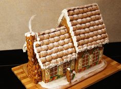 a gingerbread house on a wooden board