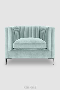 a light blue couch sitting on top of a white floor next to a gray wall