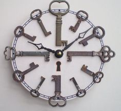 a clock made out of old keys on a white wall