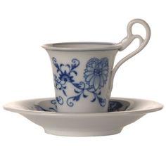 a blue and white tea cup on a saucer