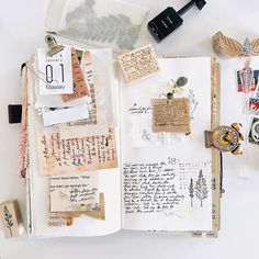 an open book with many different items on top of it and some type of writing